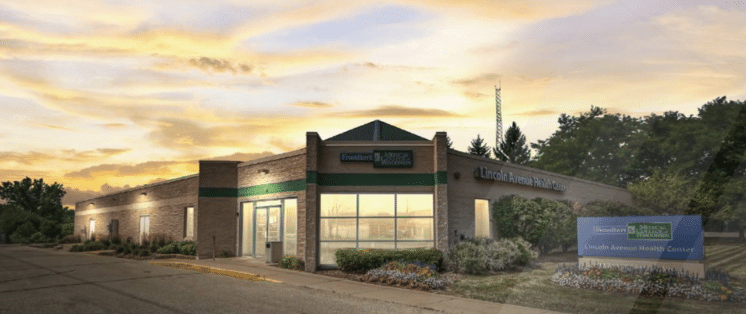 Image of a medical building in front of a sunset